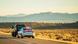 Police officers conducting a DUI checkpoint with flashing lights near a resort area in Arizona.