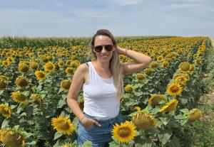 According to a recent CEPR (Center for Economic and Policy Research) analysis, 47% of U Ana Mitrovic smiling in a field of daisies, representing the freedom and fulfillment of building a successful work-from-home business as a mom using modern tools and AI.
