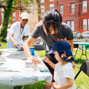 Young person participating in the community paint day hosted by Mural Arts Philadelphia