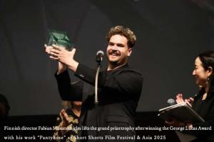Finnish director Fabian Munsterhjelm lifts the grand prize trophy after winning the George Lucas Award with his work “Pantyhose” at Short Shorts Film Festival & Asia 2025