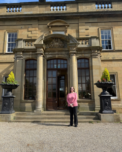 Author Nadine Theiss at the entrance of Rudby Hall