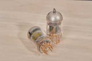 A pair of Ray Tubes RESERVE 6SN7 vacuum tubes against a light-coloured wooden background.