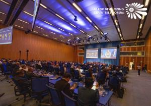 Conference attendees seated in rows at the United Nations Vienna assembly hall listening to AIFOD Summit speakers discuss AI funding inequality and development opportunities for Global South nations