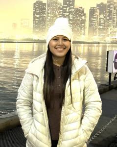 A college student poses for a photo while on a trip to Chicago