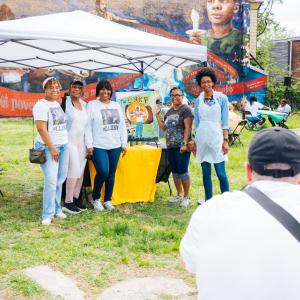 Ashley Gripper, Joey Gripper, and Naima Gripper participate in a Community Paint Day for the Unk P mural, collaborating with artist Nile Livingston to bring Paul Gripper's legacy to life through vibrant public art in North Philly