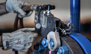 A worker uses TorqLite hydraulic torque wrenches, critical for industrial joint integrity.