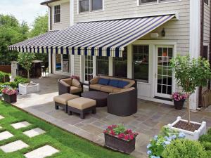 A striped retractable installed over a patio