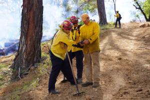 Firefighters and land manager coordinate wildfire resilience efforts during a prescribed burn in Napa County using mobile fire mapping technology.