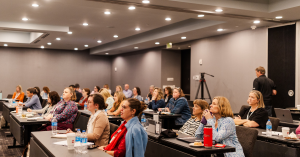 Attendees seated in a conference room listening to a workshop at the 2024 After Loss Summit, hosted by PALS in Atlanta, Georgia.
