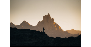 This image depicts a natural area with a person and cliff clearly separated yet together as the total area