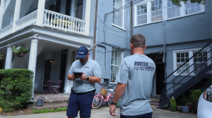 photo of two rooter man techs standing on site