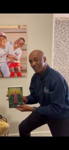 Byron Williams holding his book