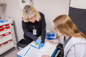 Staff showing patient medical papers with results