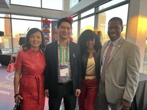Patrick Cheng, CEO of General Tso’s Restaurant & Catering, stands with three fellow business and community leaders during National Minority Business Week in Atlanta, with the city skyline in the background.
