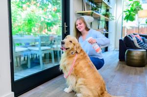 How to Prevent A Tick Takeover as U.S. Sees Increase in 2025 Tick Populations 17 Woman sprays Wondercide Flea & Tick for House & Home to prevent ticks indoors.