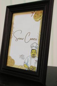 The themed snow cone sign featuring Chef Serge's likeness added a personal touch to the treats provided during the community reading session at Faith Academy.