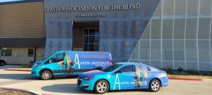 Austin Lighthouse for the Blind Achieves ISO 45001 Certification and ISO 9001 Re-Certification 13 Exterior view of Austin Lighthouse for the Blind building with two bright blue branded vehicles parked in front, showcasing the organization’s logo and mission imagery.