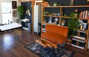 Interior of Cora Mylene’s private tattoo studio in Austin featuring natural light, plants, and a cozy artistic atmosphere