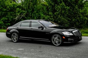 Black Mercedes-Benz S65 AMG parked on a smooth road with a reflective, polished finish after professional mobile auto detailing by Auto Love Pro Detailing in Williamsburg, Virginia.
