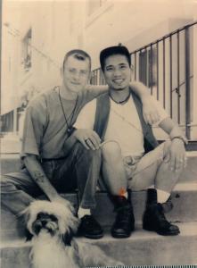 Ben Cable (left) is seated on the steps with Marcial Cable-McCarthy of an apartment building with their long haired dog