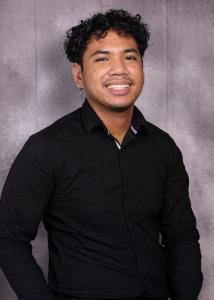 Jeremiah Ramiscal, smiling in a black shirt, CX Specialist at Quilia.