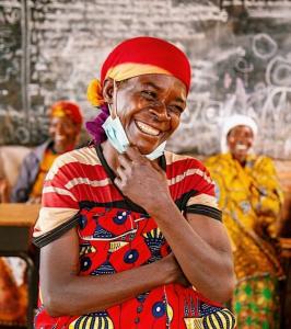 Joyful woman in colorful attire, symbolizing the positive social impact supported by HERO SHOT’s corporate photography donations.