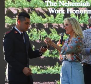 Celeste White receiving the Nehemiah Award from the Salvation Army