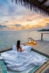 Sunset over the water bungalow at Cinnamon Hakuraa Huraa Maldives