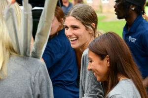 An RBC woman student laughing with her teammates.