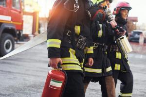 Group of firefighters walking in gear after responding to a call, symbolizing the lasting impact of trauma in the fire service.