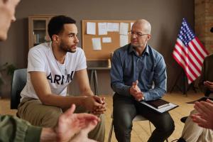 First responder in a therapy session with a counselor, representing mental health support and addiction recovery care.