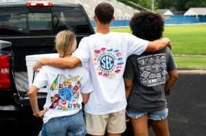 Three people wearing SEC shirts
