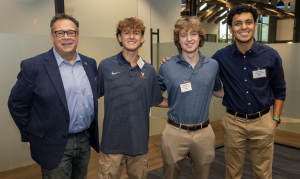 2025 7x24 Exchange DC Chapter Education Committee Chair Don Miller poses with some of this year's scholarship recipients.