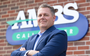 Aaron Boatin standing outside of Ambs Call Center's Jackson, Michigan office building