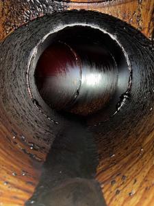 A dirty exhaust duct that is about to be cleaned by a Filta Kleen technician