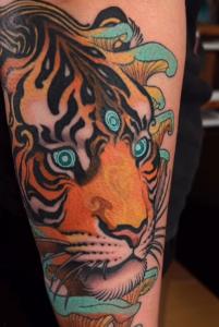 A psychedelic art neo-traditional tiger tattoo by Austin tattoo artist Cora Mylene