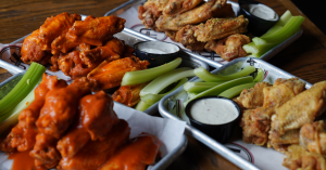 Universal Joint, the neighborhood gathering spot known for burgers, rotating taps, and dog-friendly patios, is kicking off football season on September 1 with two exciting new promotions designed for game-day eats Universal Joint wings stacked high