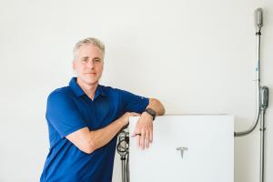 Man by a battery for solar