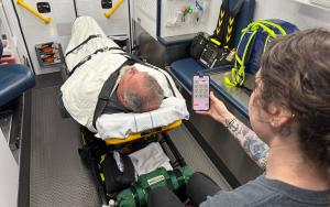 Photo of a patient on a gurney inside an ambulance with a Stanly County EMS provider using Hinckley Medical’s OneDose® on a mobile device.