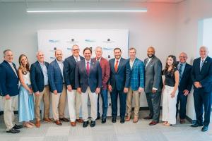 Group picture of the speakers including Governor Ron DeSantis at the Grand Opening and Ribbon Cutting Celebration of the Seacoast Collegiate High School and Northwest Florida State College South Walton Center.