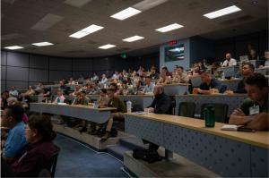 Naval Postgraduate School (NPS) students listen to keynote presentations during the Warfare Innovation Continuum workshop on Non-Permissive Global Sea Control.