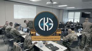 Logo of CKG with a background of cyber training by uniformed personnel