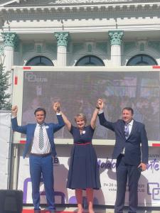 Adriano Dulgher and fellow CUB (Coaliția pentru Unitate și Bunăstare) leaders stand on stage in Chișinău, Moldova, raising their hands in unity during a political rally ahead of the 2025 elections. The event highlights CUB’s commitment to democracy, anti-