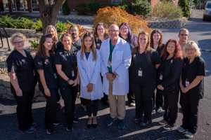 Medical staff posing for a group photo outside the building