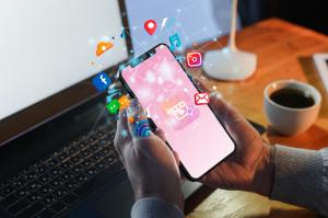 A person browsing their smartphone for online shopping, with social media icons like Facebook and Instagram floating from the screen, representing how social platforms influence e-commerce purchases