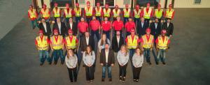 Schulte Roofing®, the premier Brazos Valley roofing company, has achieved a historic milestone by securing its 15th consecutive victory at the prestigious Best of Brazos Valley (BOBV) 2024 Awards Group photo of Schulte Roofing team in safety vests, hard hats, and business attire standing together outside headquarters.
