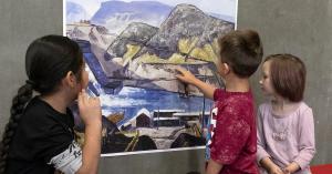 Children look at a copy of a painting by Clyfford Still of the Grand Coulee Dam under construction in the 1930s