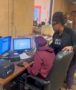 Natasha Broxton, CEO of Select Auto Parts, collaborating with staff in Milwaukee office, demonstrating leadership and teamwork.