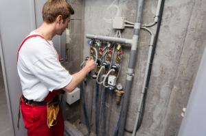Castaneda’s Plumbing and Rooter is proud to announce the official launch of its full suite of residential and commercial plumbing services Plumber tightening a residential water meter connection using an adjustable wrench.