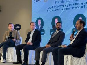 Feras Mousilli on the speaking panel at SYNC conference in Syria
